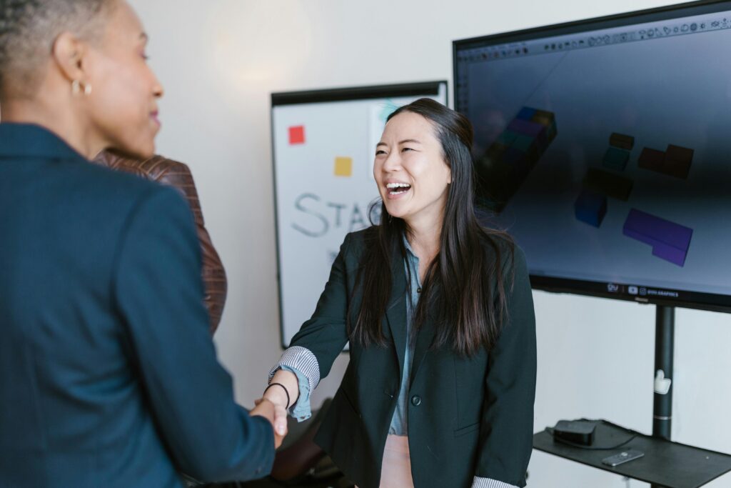 Two sales leaders shaking hands.