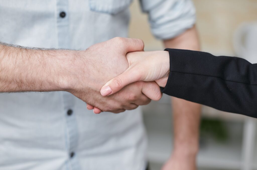 Two people shaking hands. 